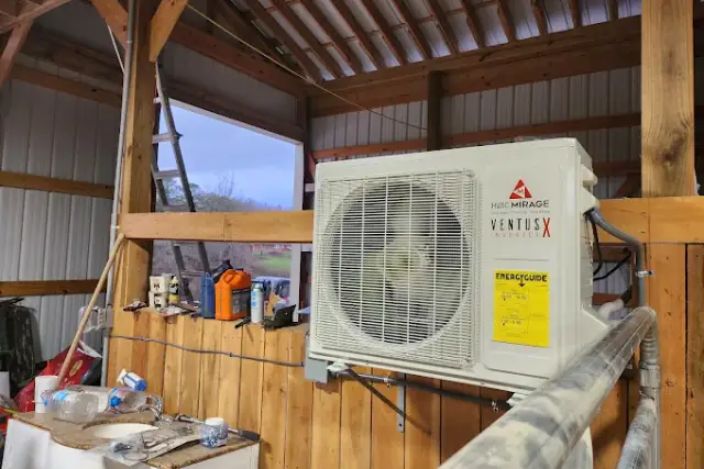 The yellow EnergyGuide efficiency label on a newly installed ductless mini split condenser